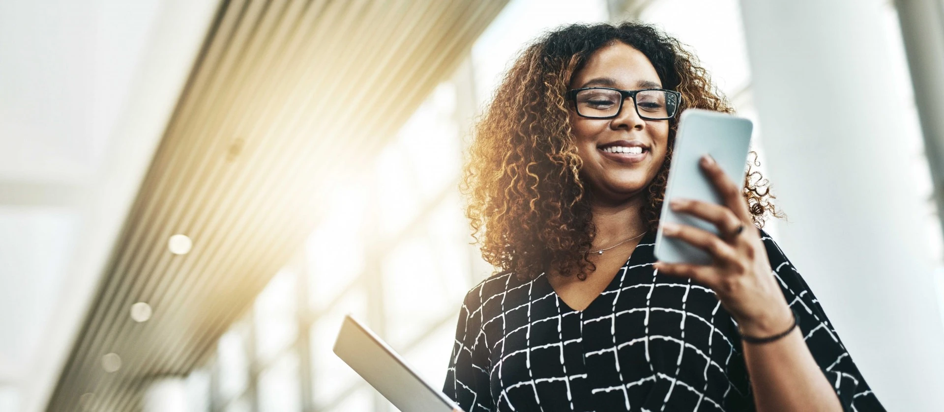 Woman smiling looking at mobile phone